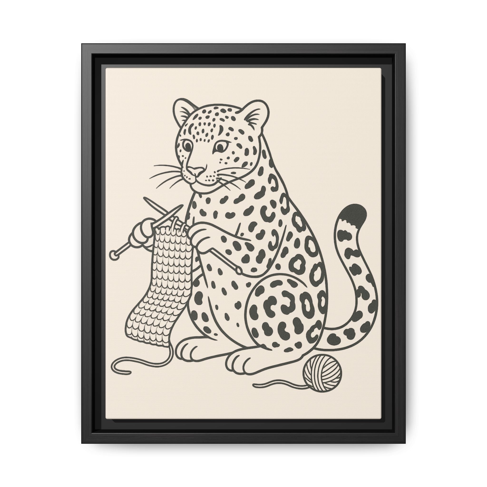 Framed artwork of an amur leopard with knitting needles and yarn on a beige background