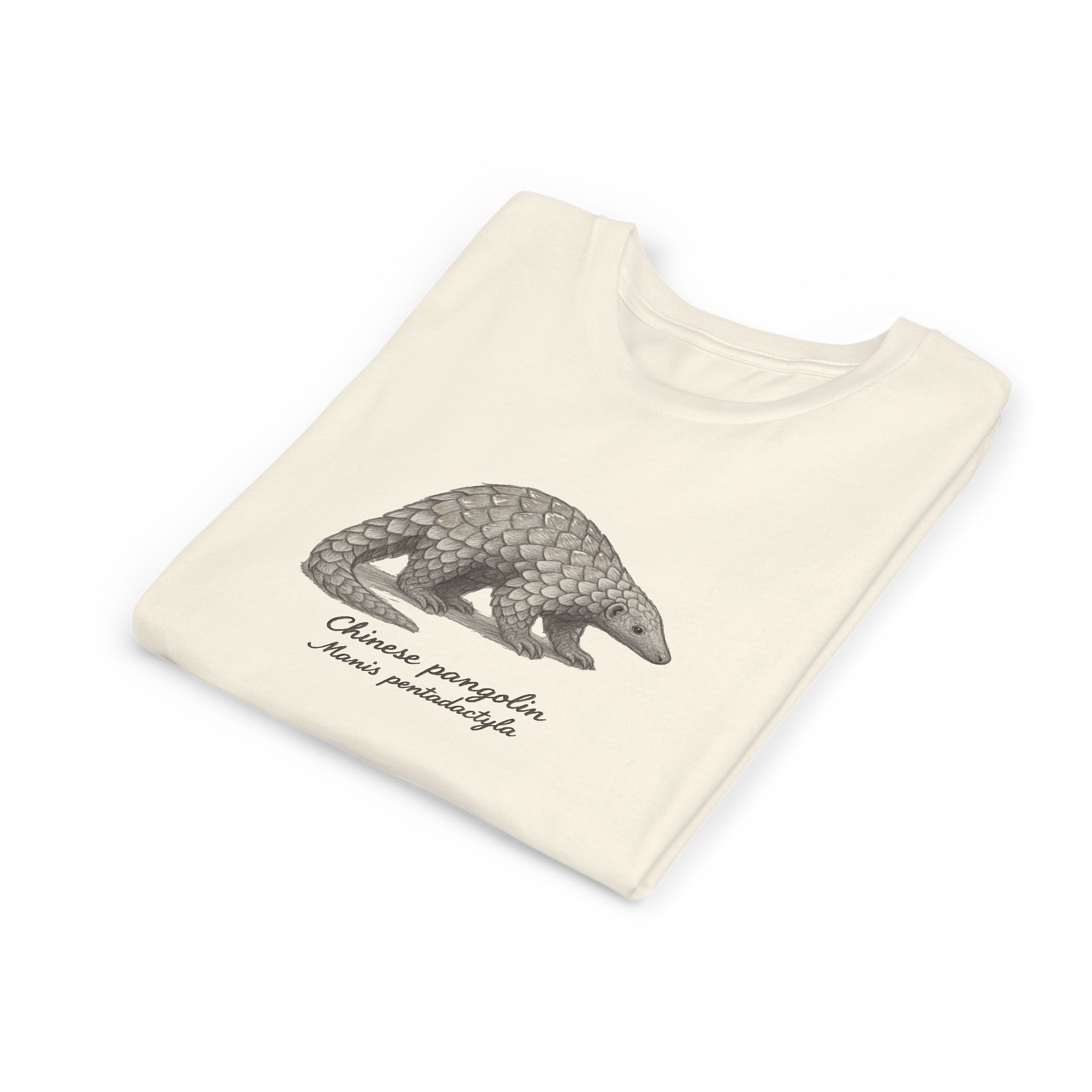 Folded beige kids t-shirt with a Chinese pangolin illustration and its scientific name on a white background