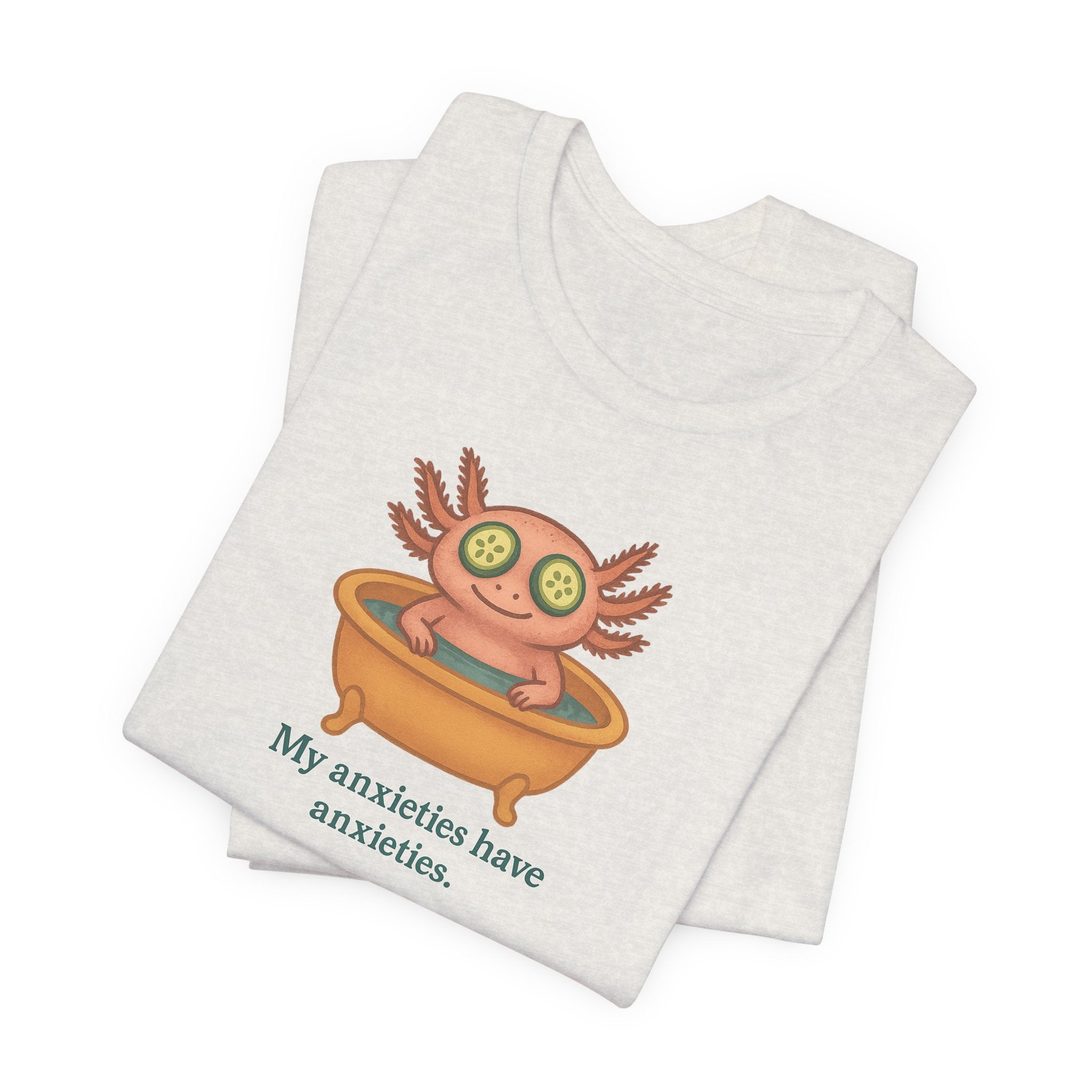 White t-shirt with a cartoon axolotl and text "My anxieties have anxieties" on a white background