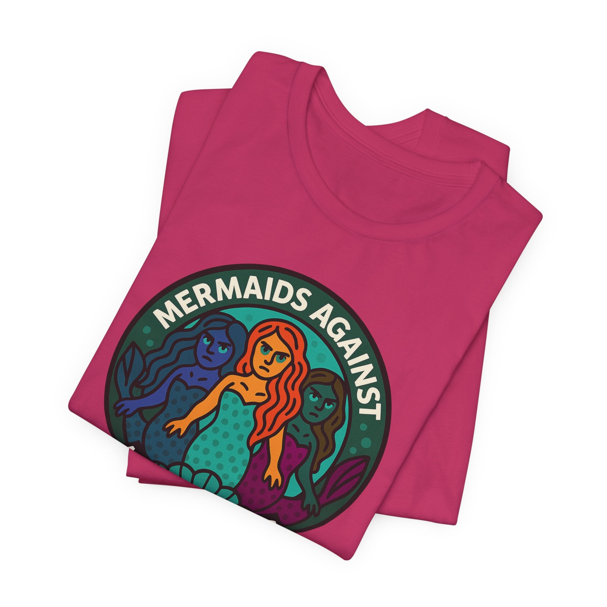 Folded pink t-shirt with mermaid graphic and text 'Mermaids Against Microplastics' by Soon To Be Mythical