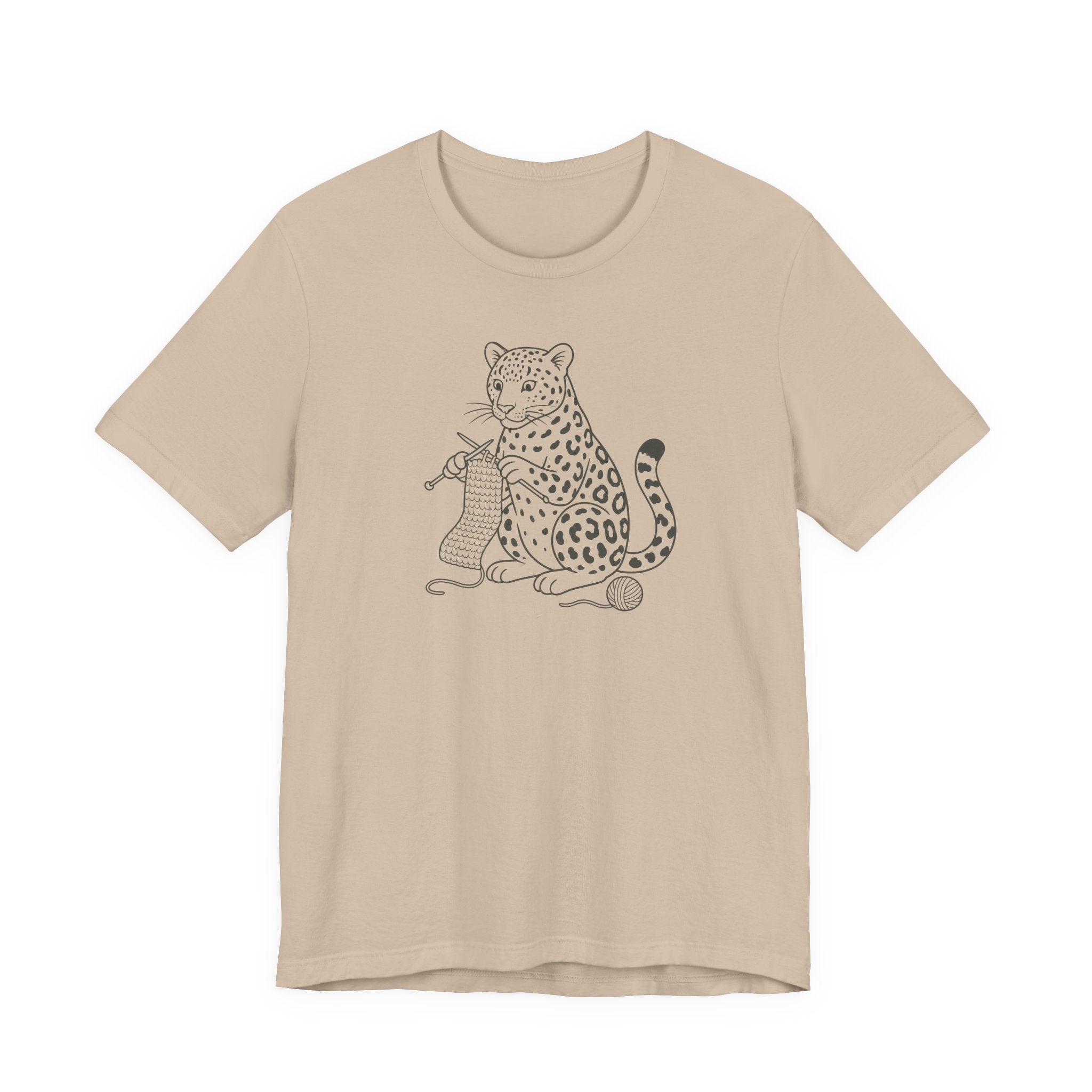 Tan t-shirt with a leopard design knitting a scarf on a white background