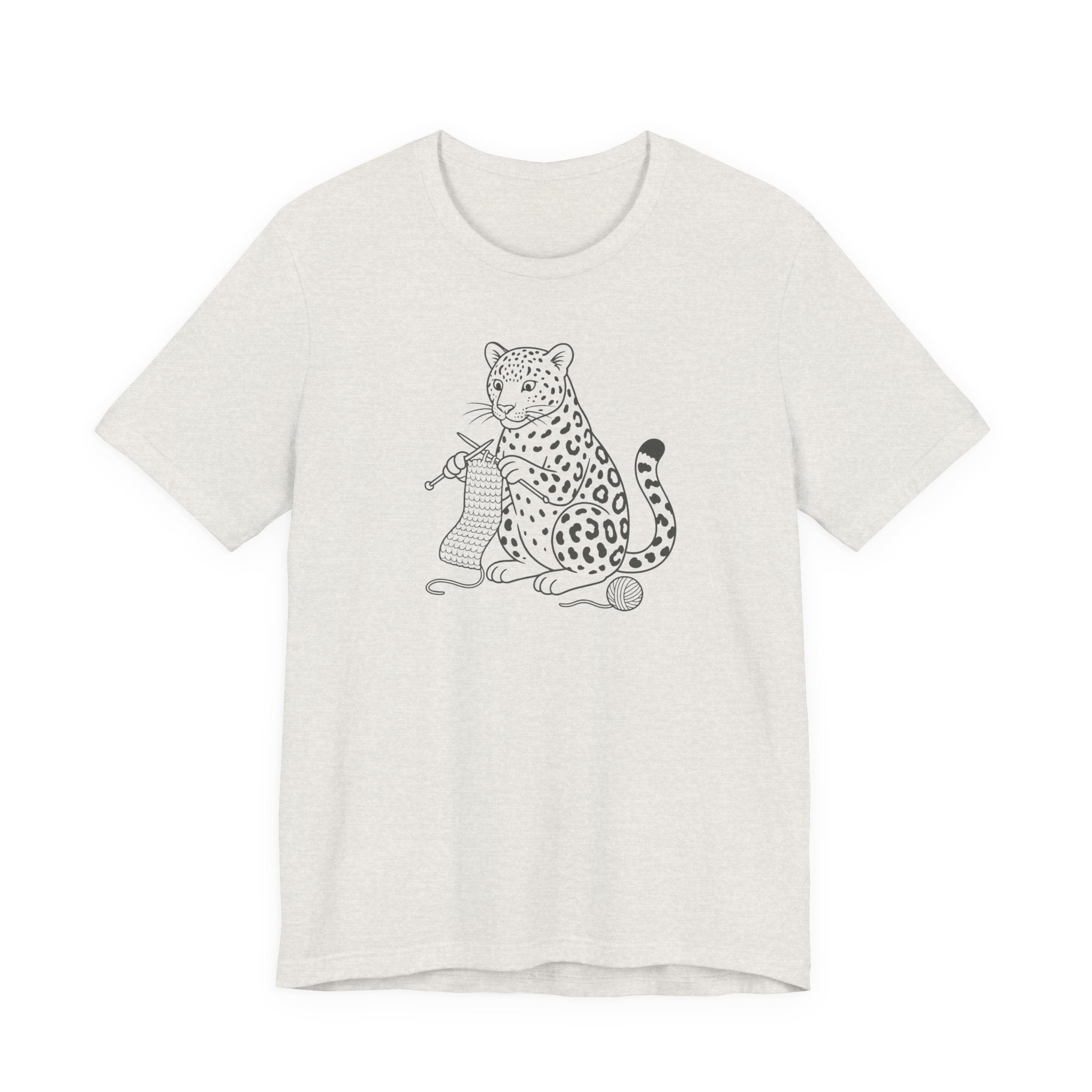 Heathered cement t-shirt with a black and white graphic of a leopard knitting a scarf on a white background