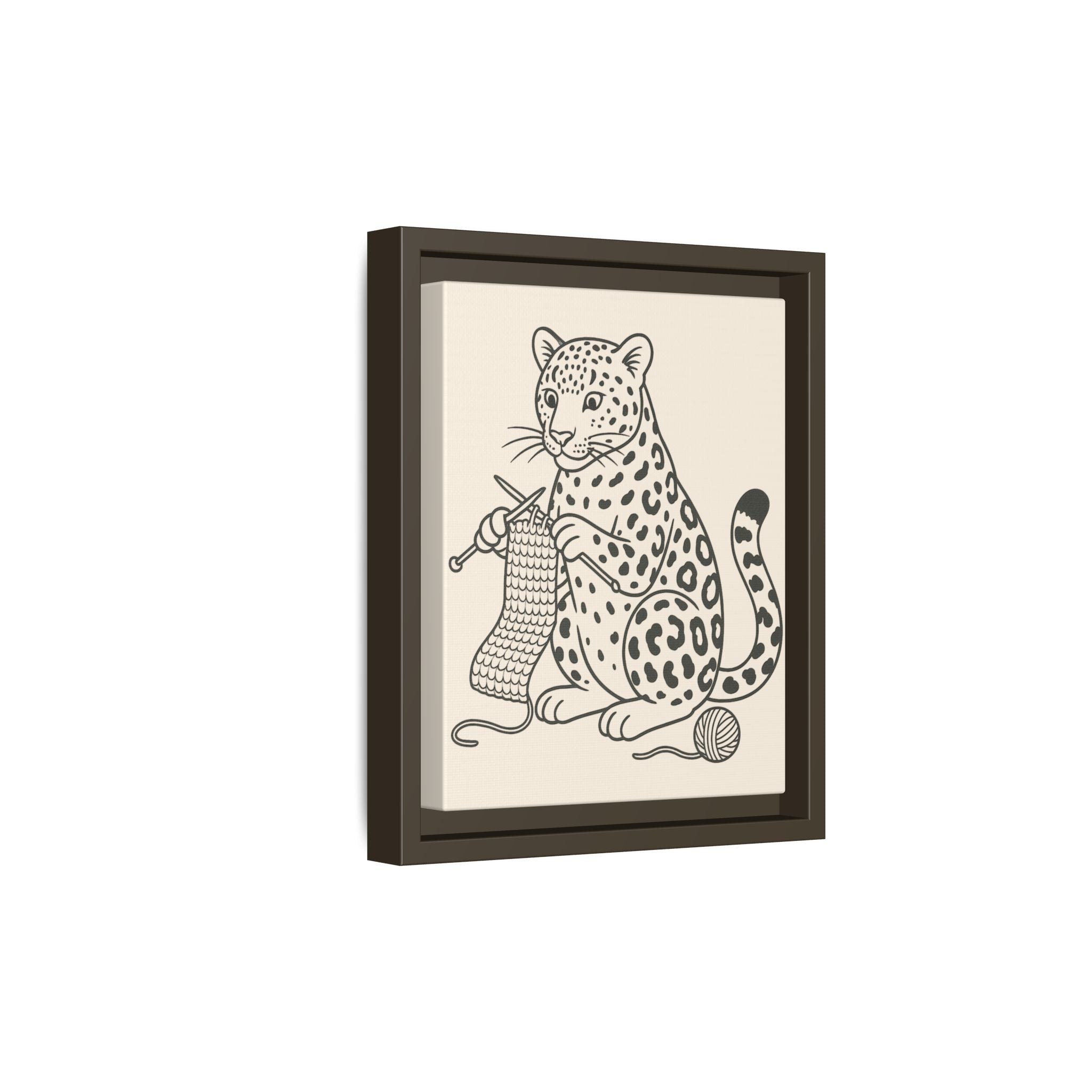 Framed artwork of an amur leopard knitting on a beige background