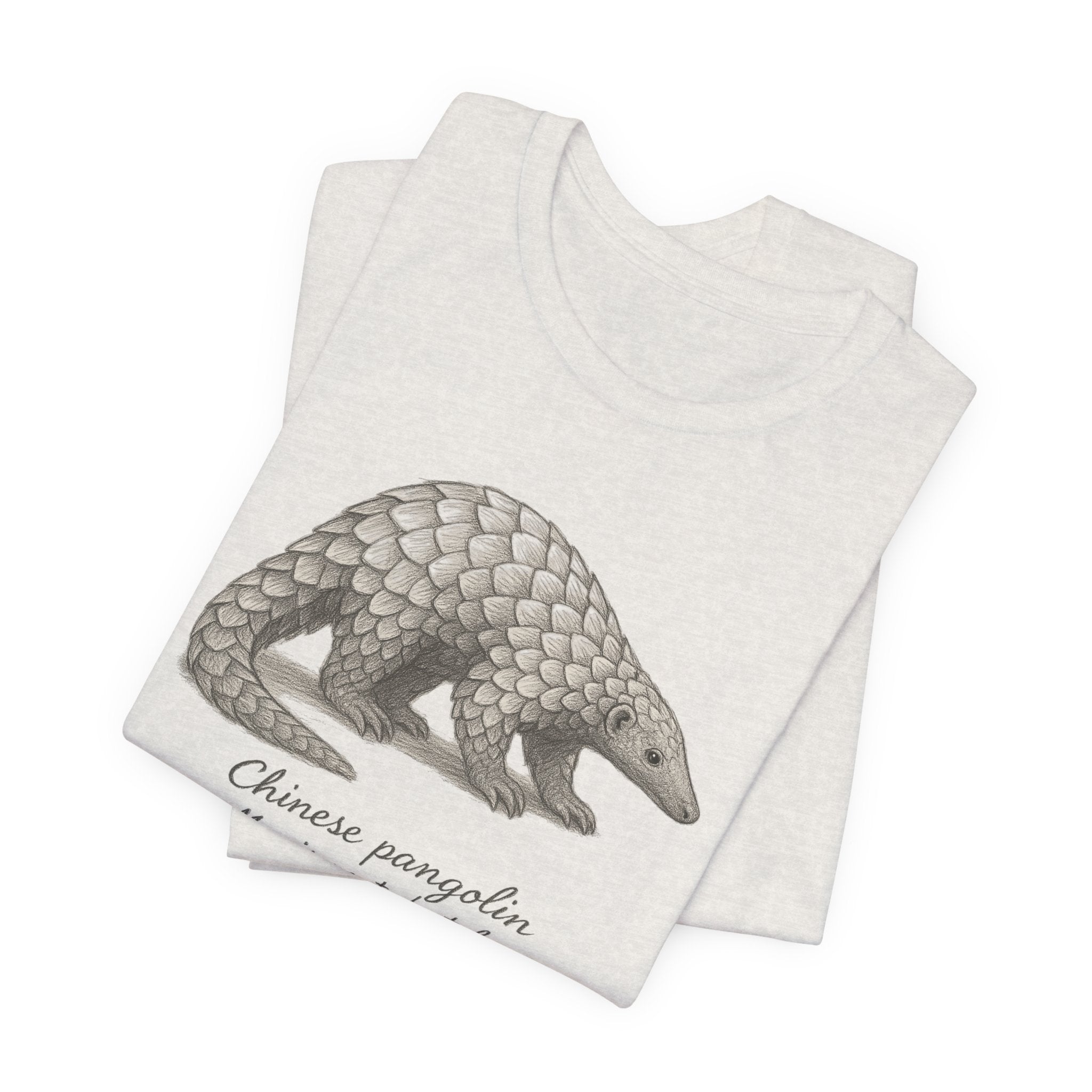 Folded heathered beige t-shirt with a Chinese pangolin design on a white background