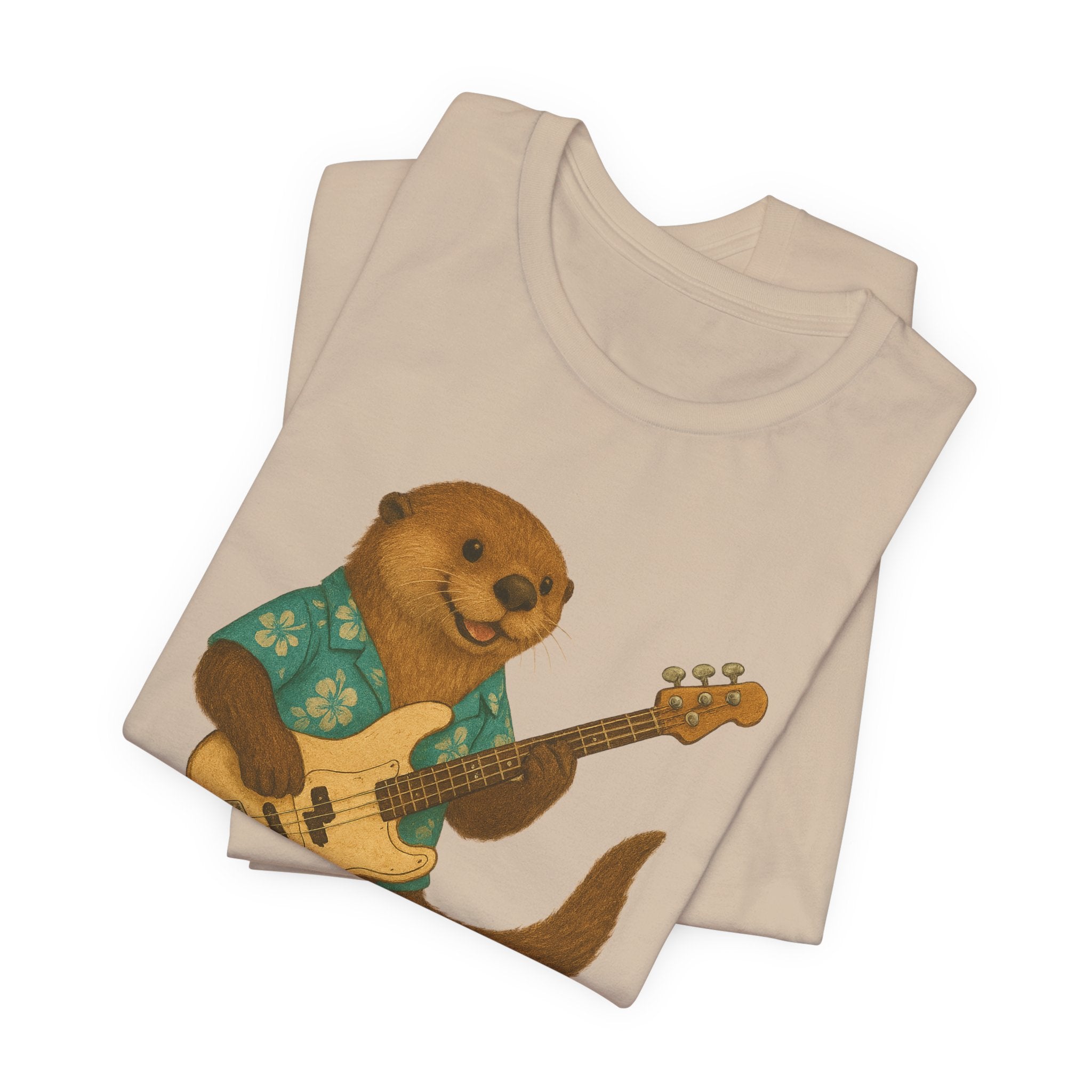 Tan t-shirt with a sea otter wearing a hawaiian shirt and playing a bass guitar graphic on a white background