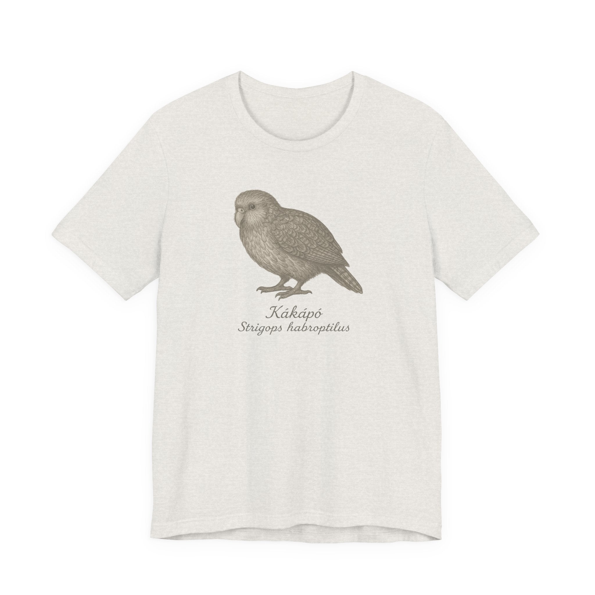 Heather cement t-shirt with a kakapo bird graphic and text of its scientific name on a white background