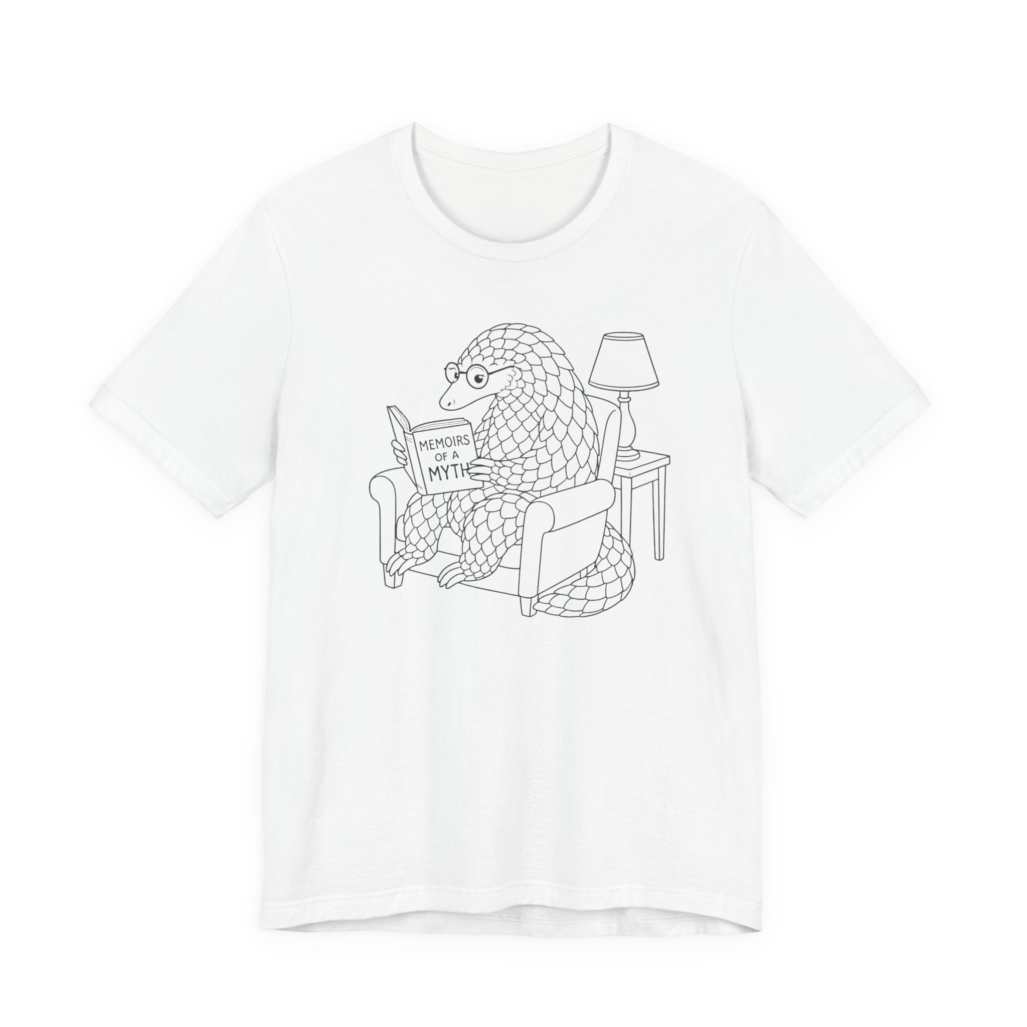 White t-shirt with a black line drawing of a pangolin reading a book titled &#39;Memoirs of a Myth&#39; on a white background.