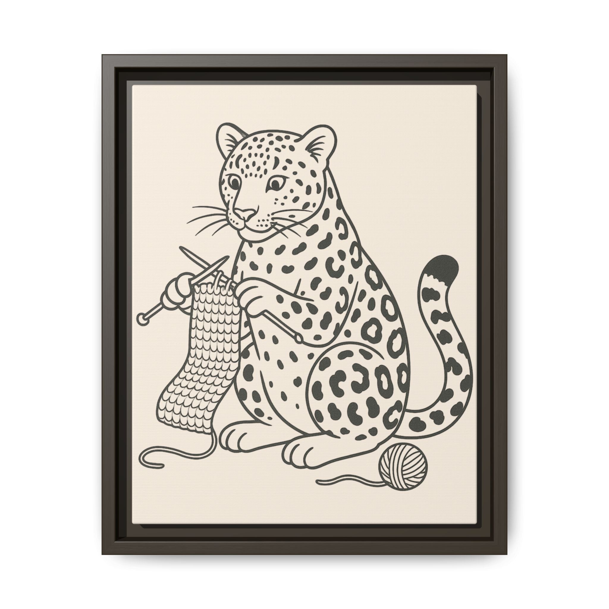 Framed artwork of an amur leopard with knitting needles and yarn on a beige background
