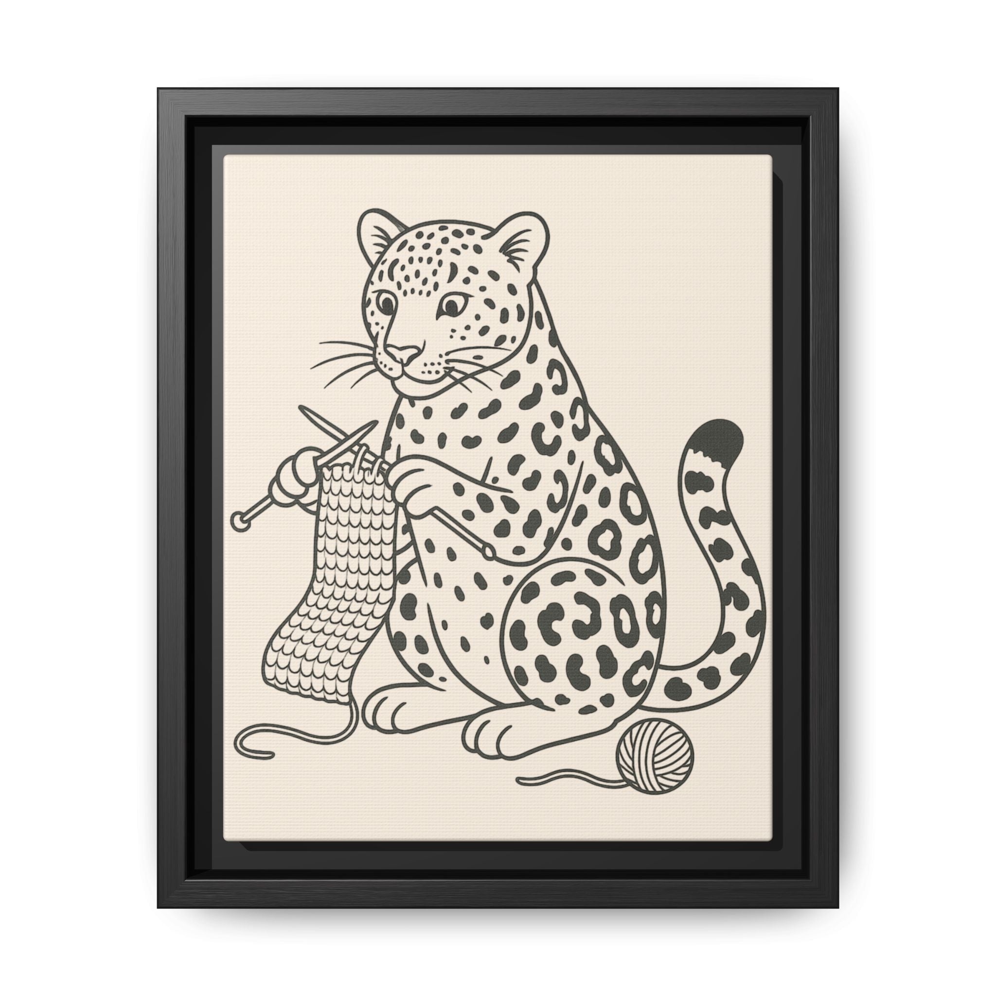 Framed artwork of an amur leopard with knitting needles and yarn on a beige background