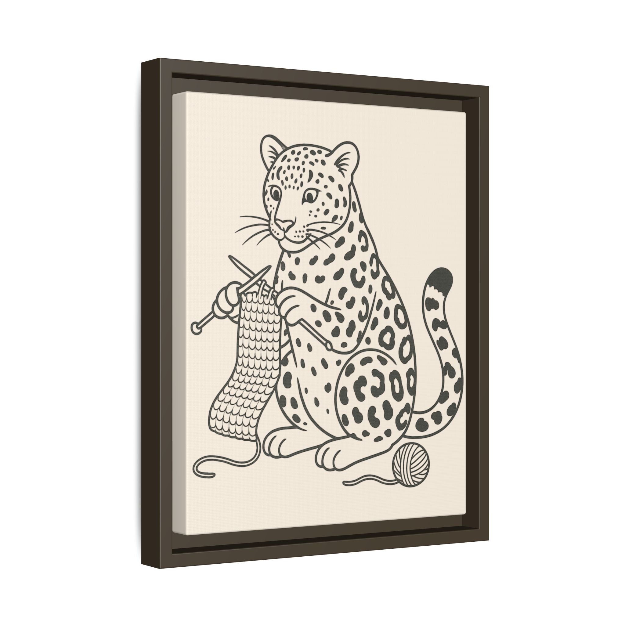 Framed artwork of an amur leopard knitting with yarn and a ball on a beige background