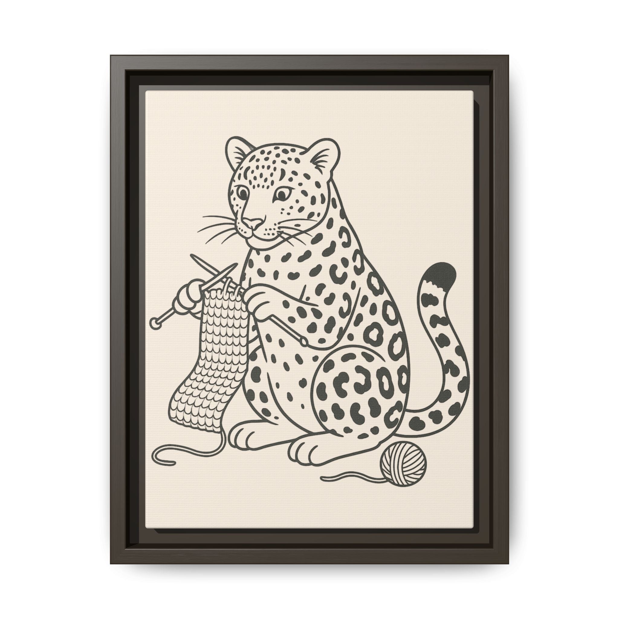 Framed artwork of an amur leopard with knitting needles and yarn on a beige background