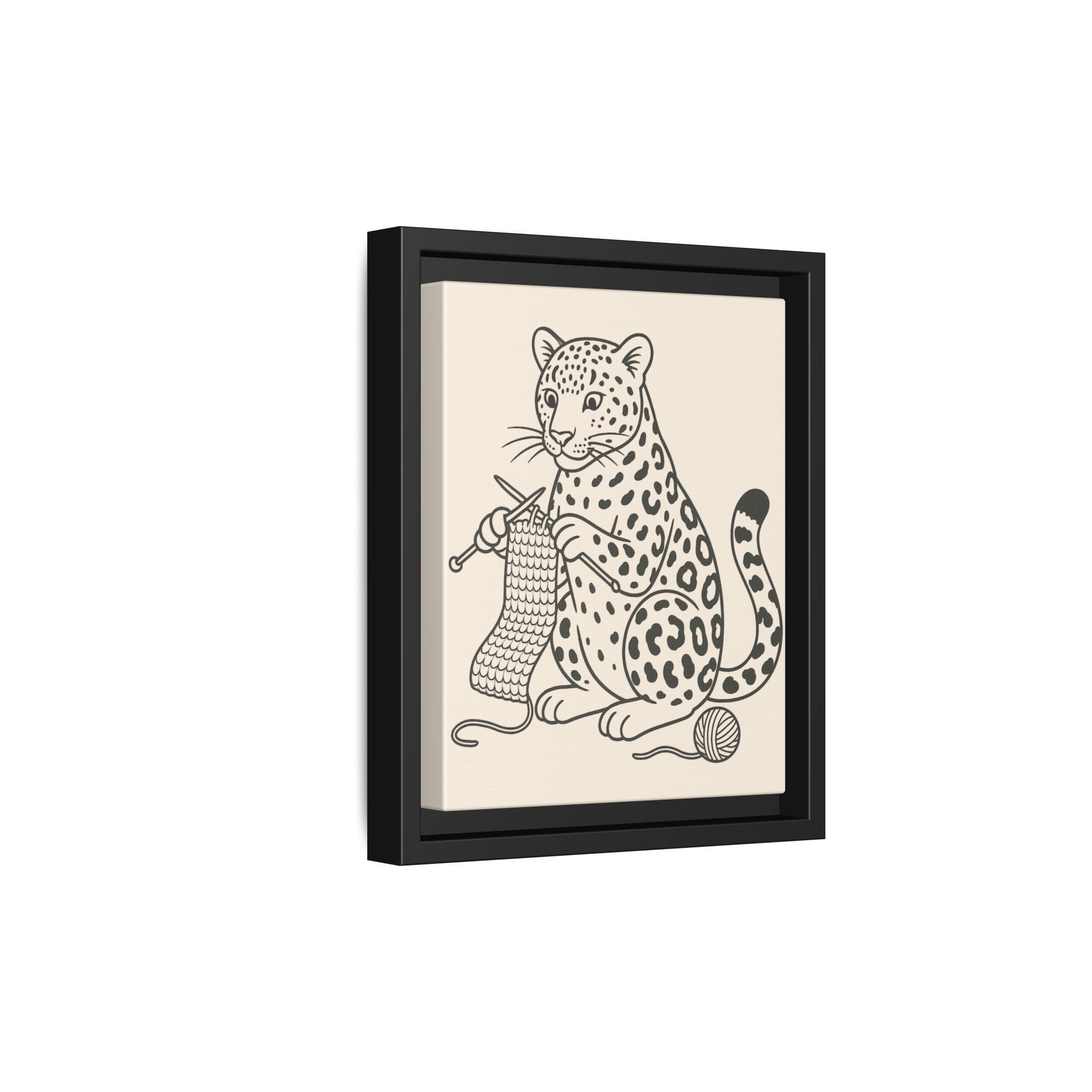 Framed artwork of an amur leopard knitting on a beige background