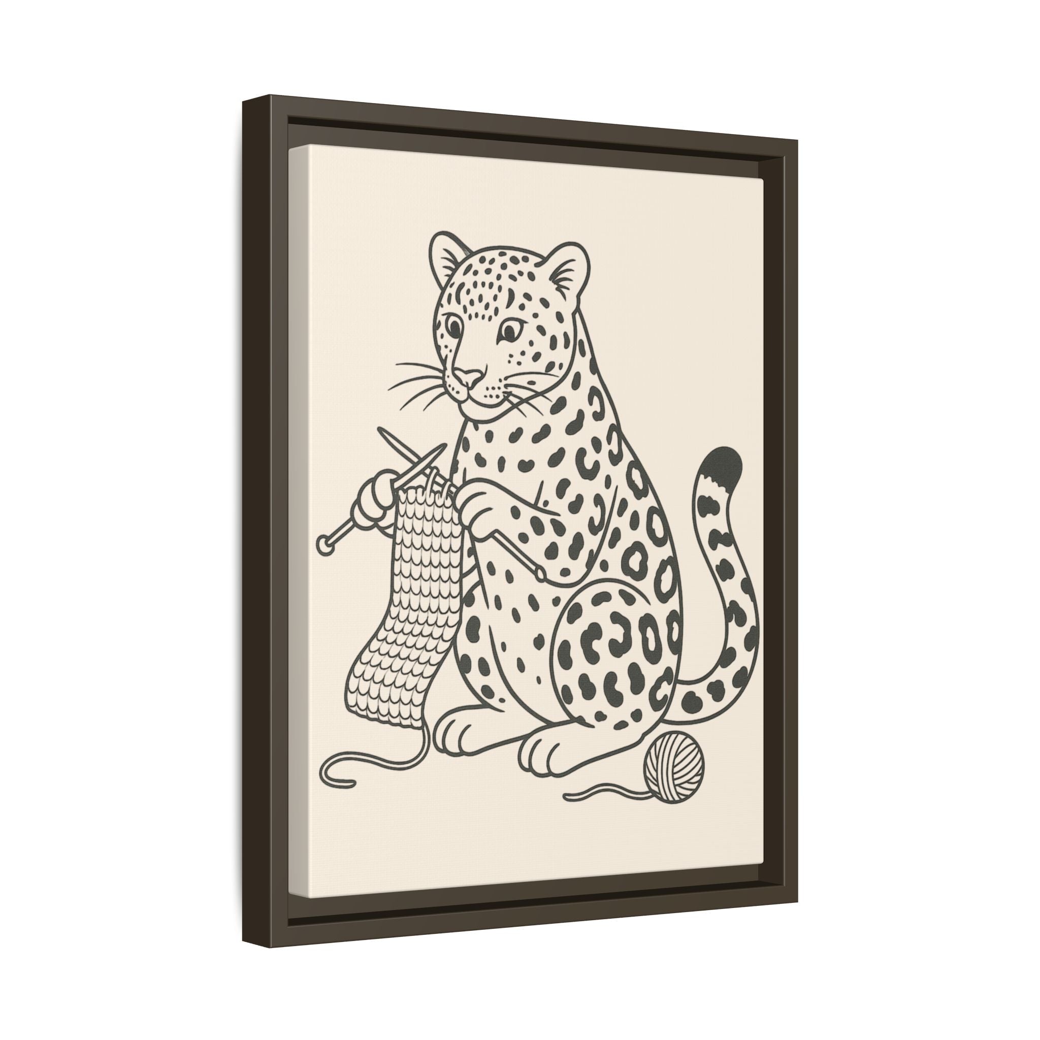 Framed artwork of an amur leopard with knitting needles and yarn on a beige background