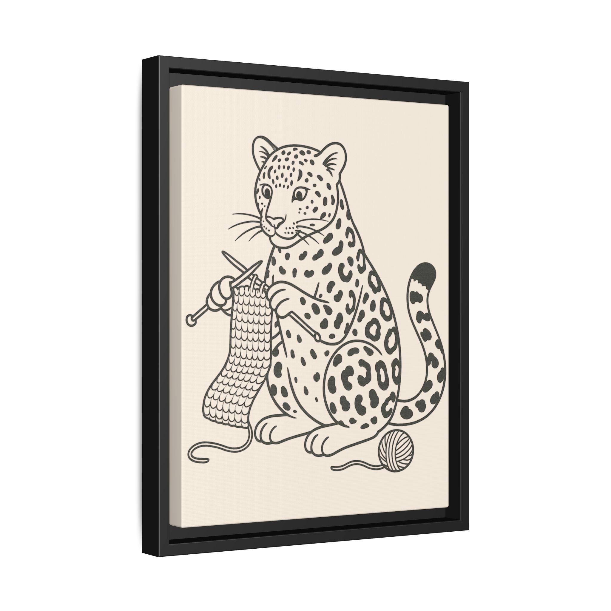 Framed artwork of an amur leopard with knitting needles and yarn on a beige background