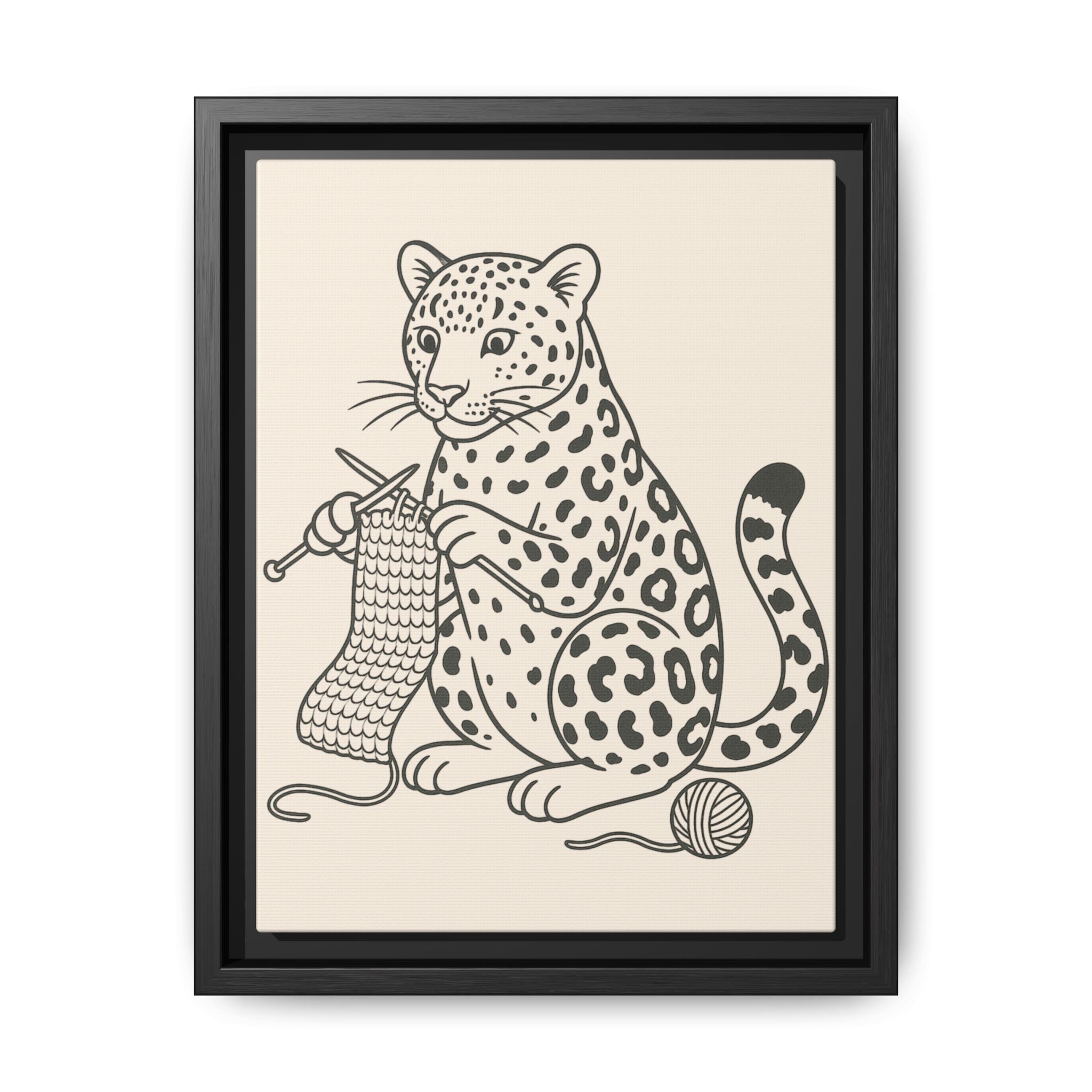 Framed artwork of an amur leopard with knitting needles and yarn on a beige background