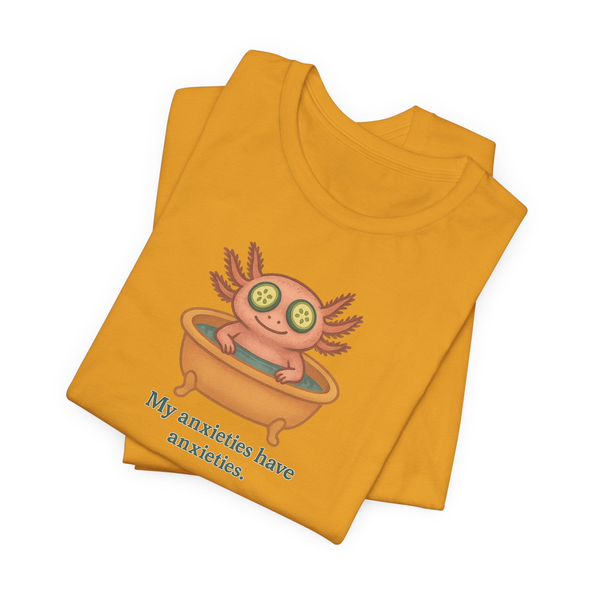 Yellow t-shirt with a cartoon axolotl and text "My anxieties have anxieties" on a white background