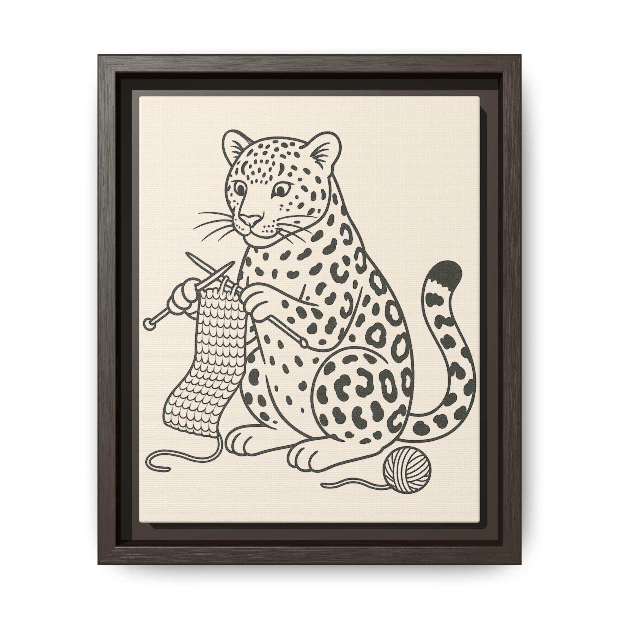 Framed artwork of an amur leopard with knitting needles and yarn on a beige background