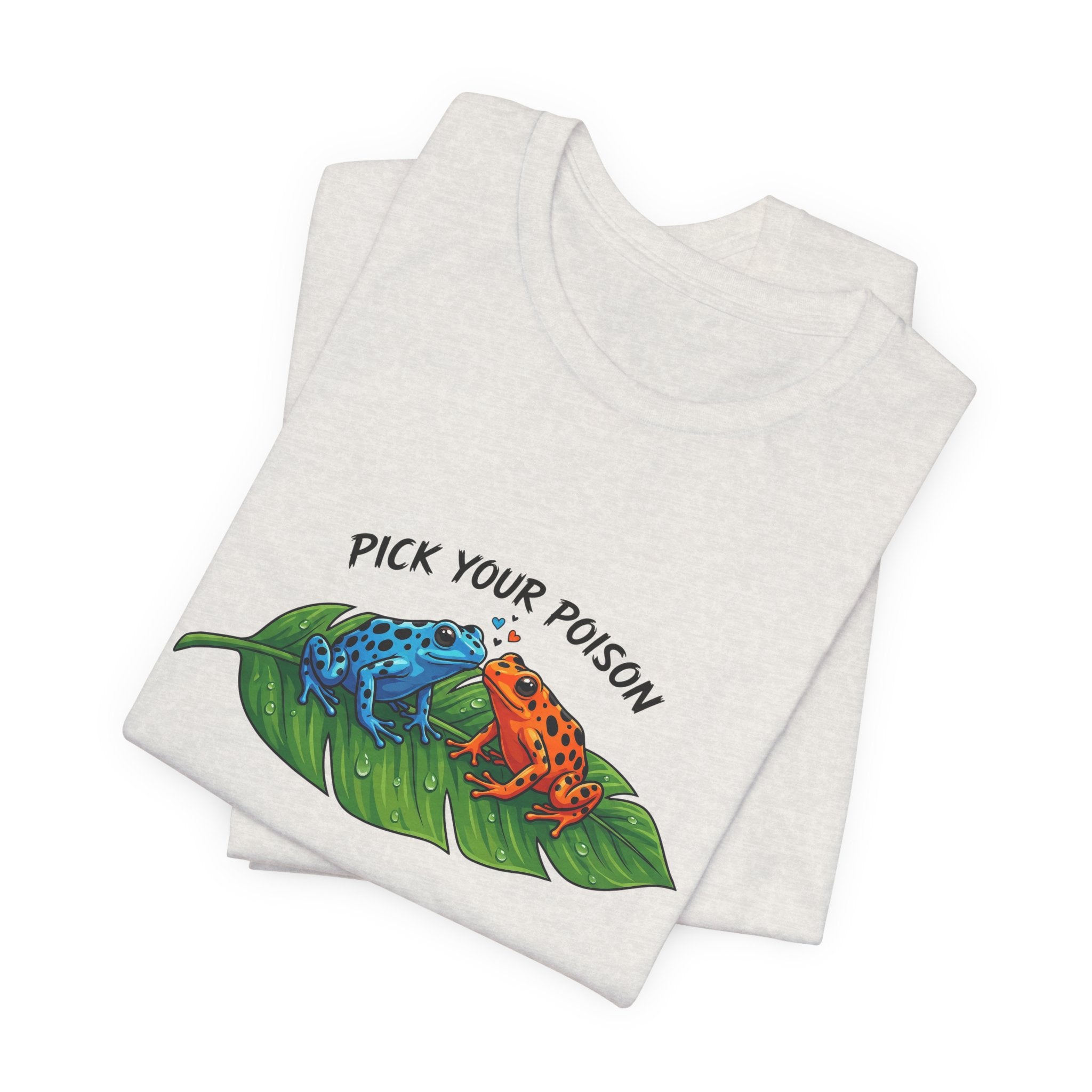 Folded heather cement t-shirt with a graphic of two poison dart frogs on a leaf and 'Pick Your Poison' text by Soon To Be Mythical