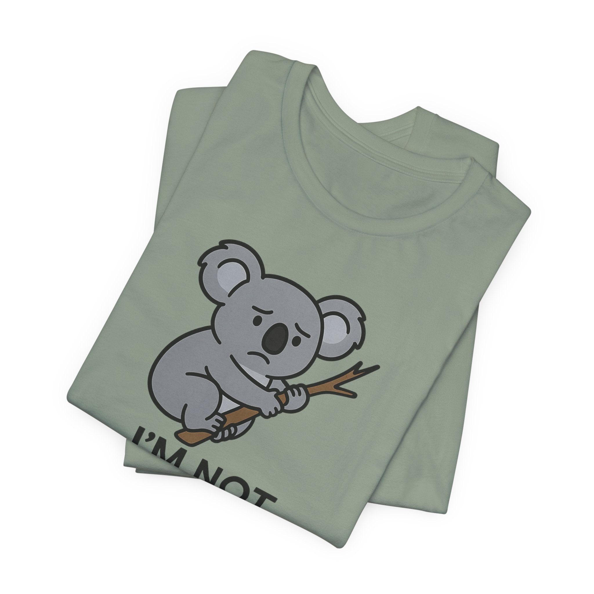 Sage green t-shirt with a koala graphic and text "I'm not koala-fied for this" on a white background