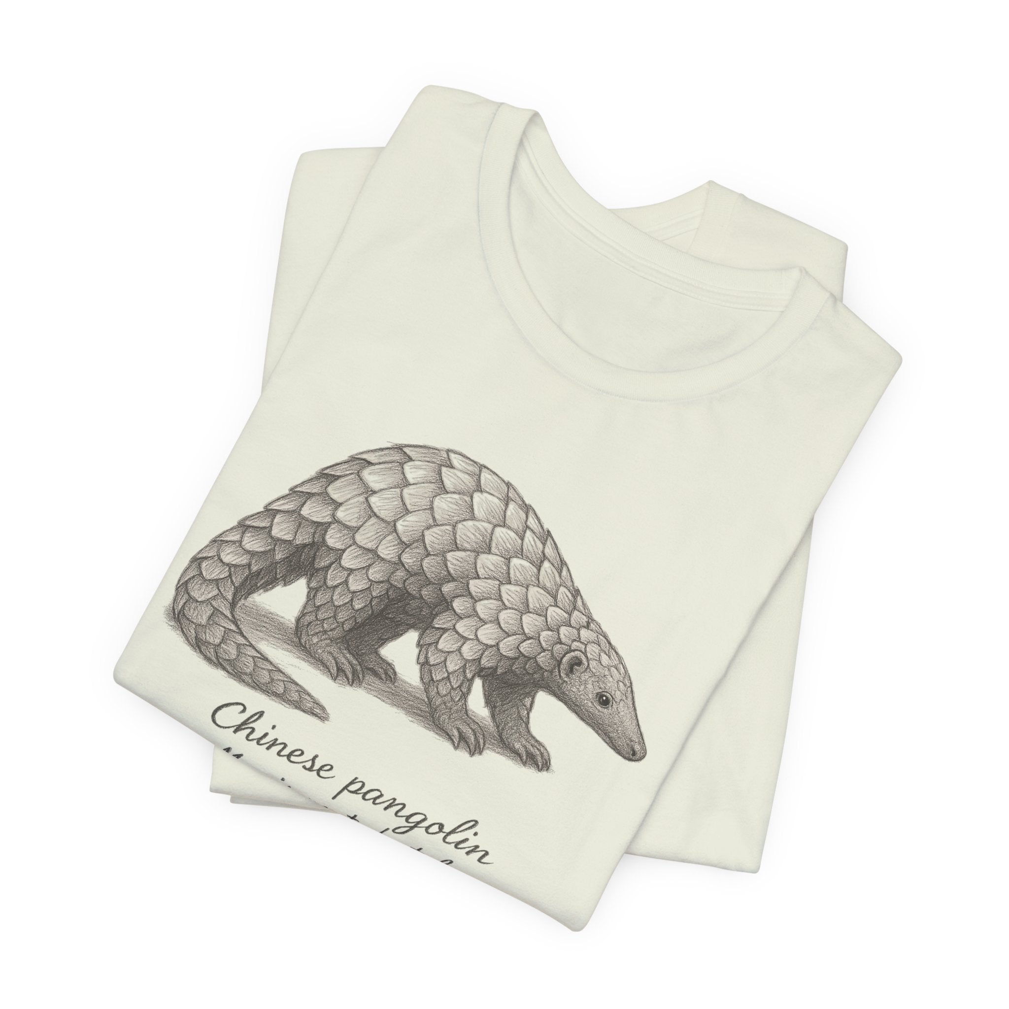 Folded citron t-shirt with a Chinese pangolin illustration on a white background