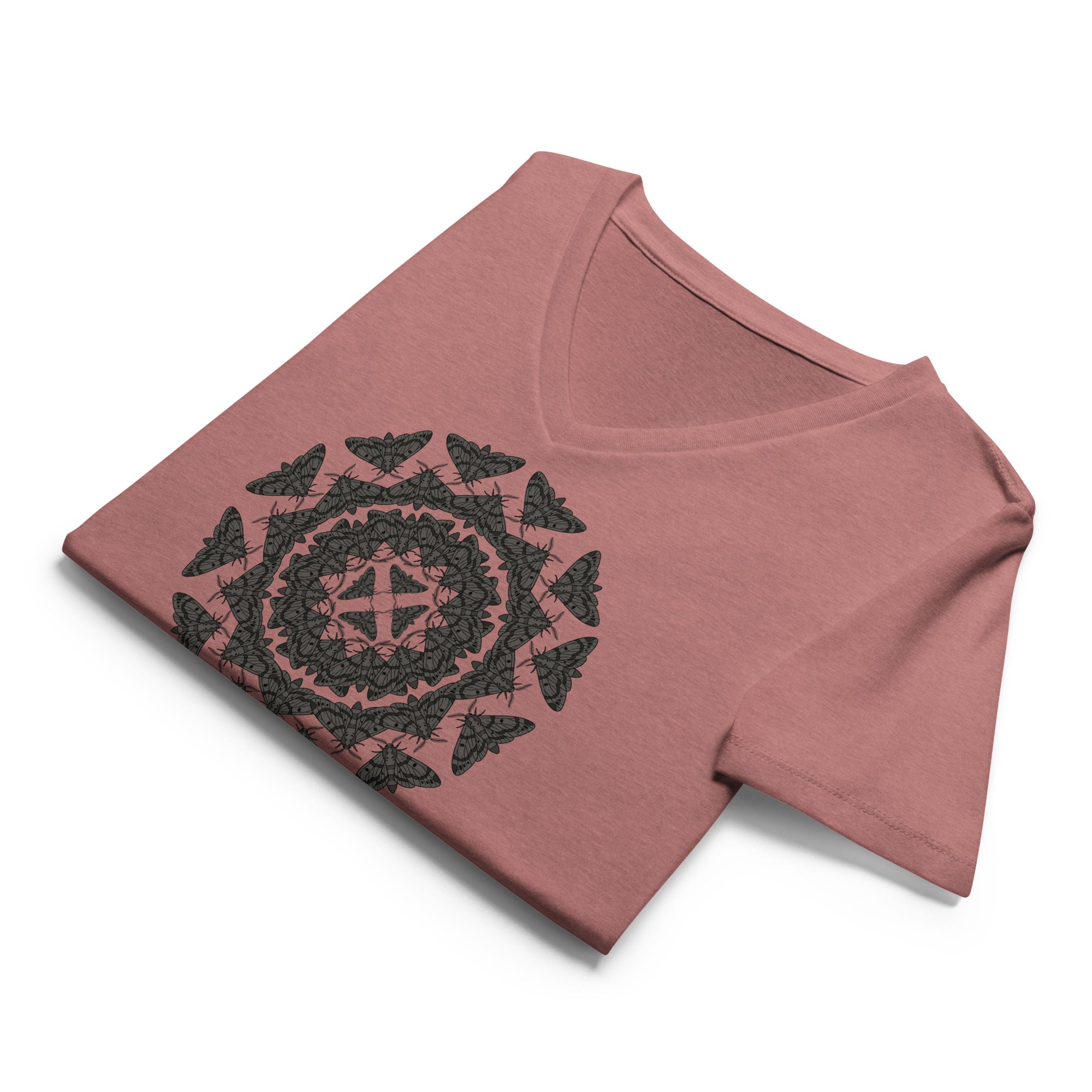 Folded mauve v-neck t-shirt with a geometric pattern of the Blackburn's sphynx moth by Soon To Be Mythical