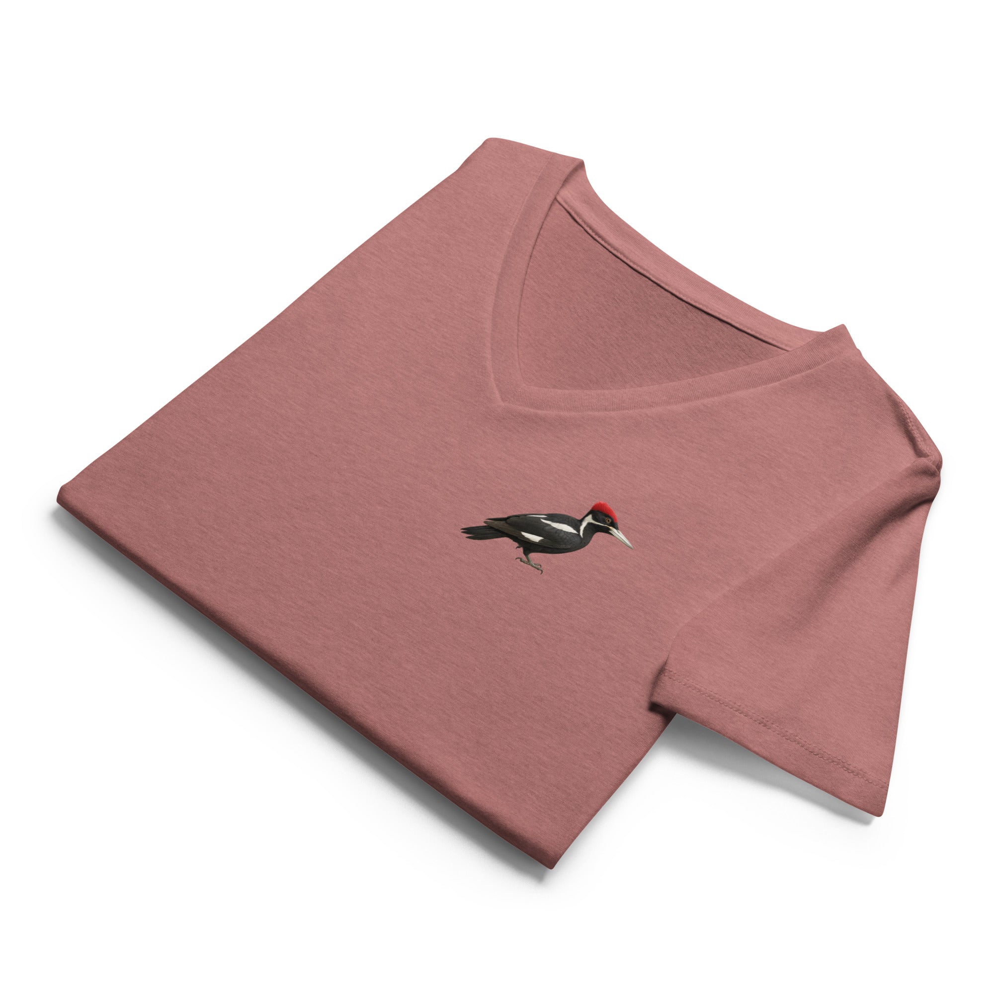 Folded mauve v-neck t-shirt with an ivory billed woodpecker design on the left chest by Soon To Be Mythical