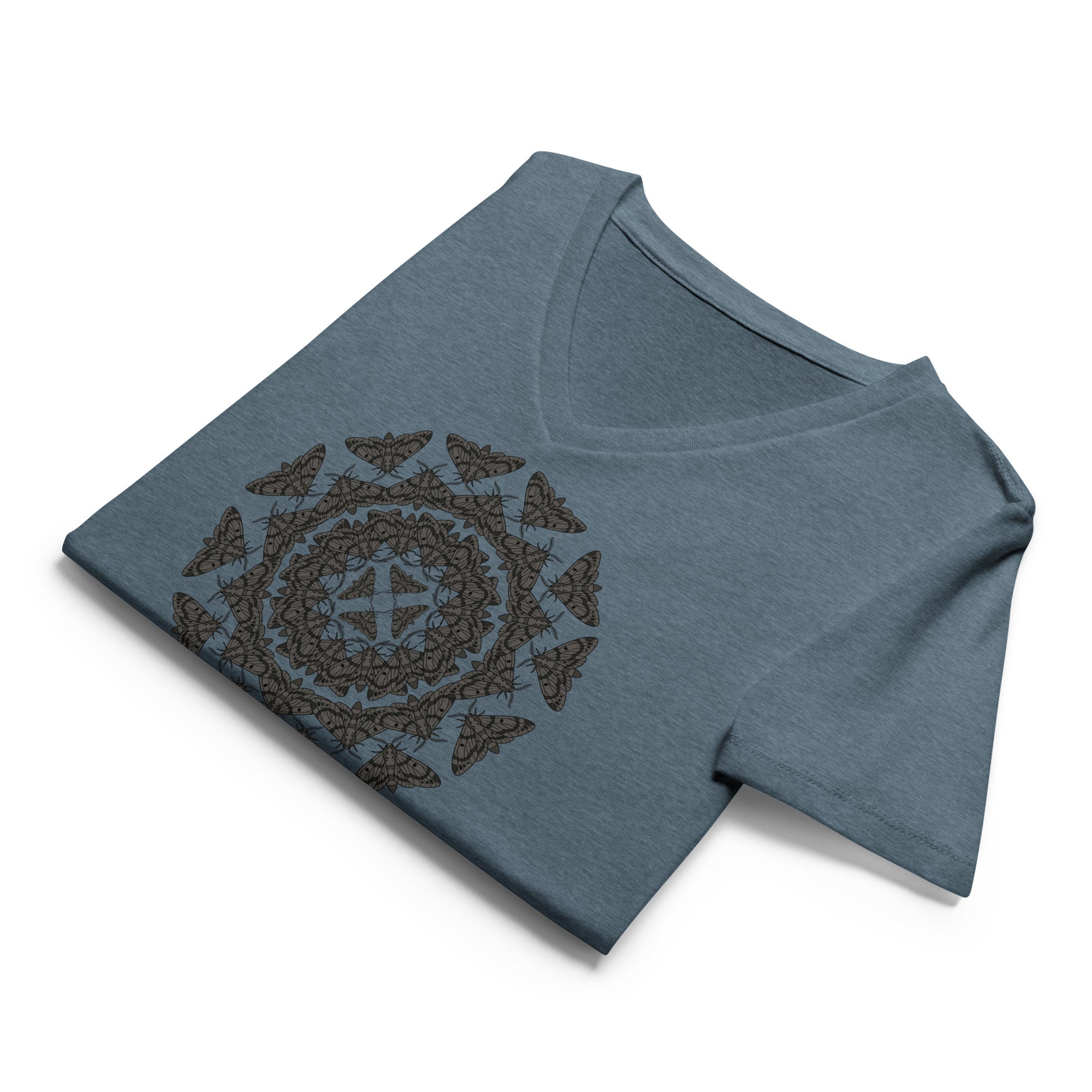 Folded blue v-neck t-shirt with a geometric pattern of the Blackburn's sphynx moth by Soon To Be Mythical