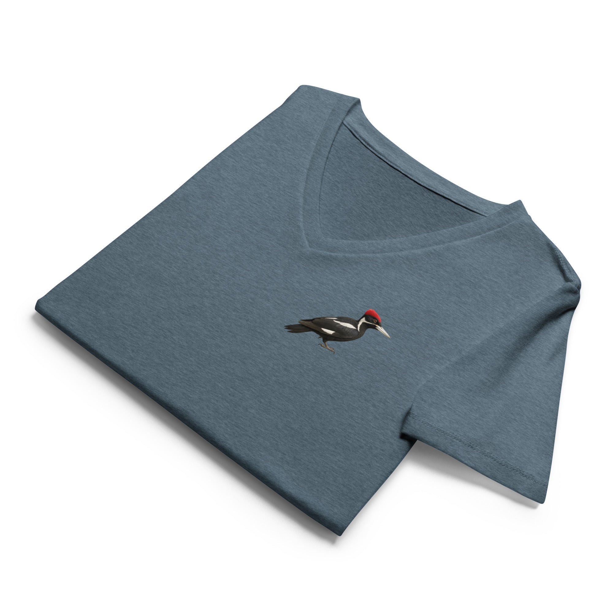 Folded blue v-neck t-shirt with an ivory billed woodpecker design on the left chest by Soon To Be Mythical