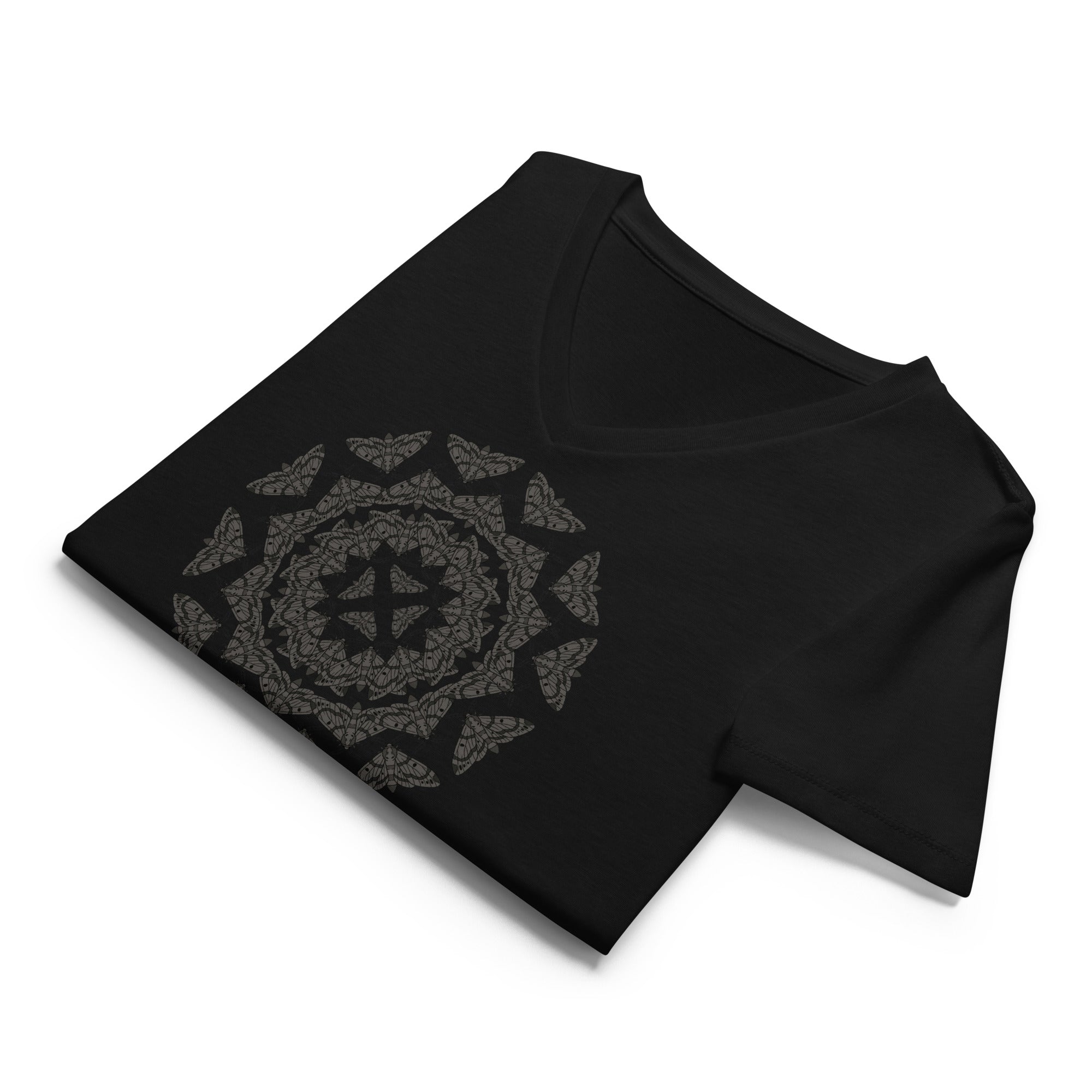 Folded black v-neck t-shirt with a geometric pattern of the Blackburn's sphynx moth by Soon To Be Mythical