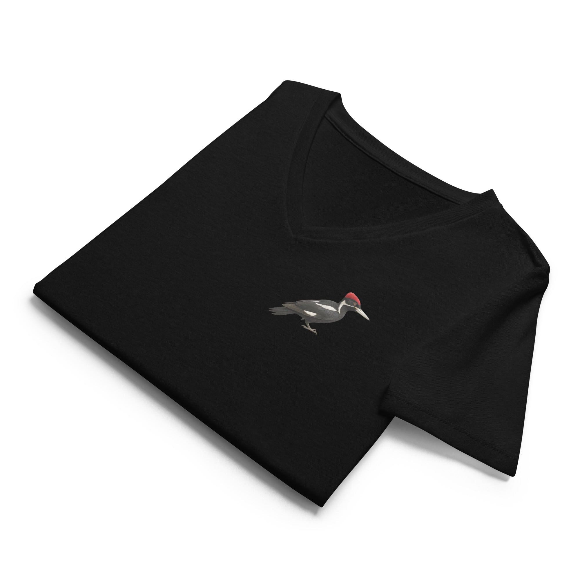Folded black v-neck t-shirt with an ivory billed woodpecker design on the left chest by Soon To Be Mythical