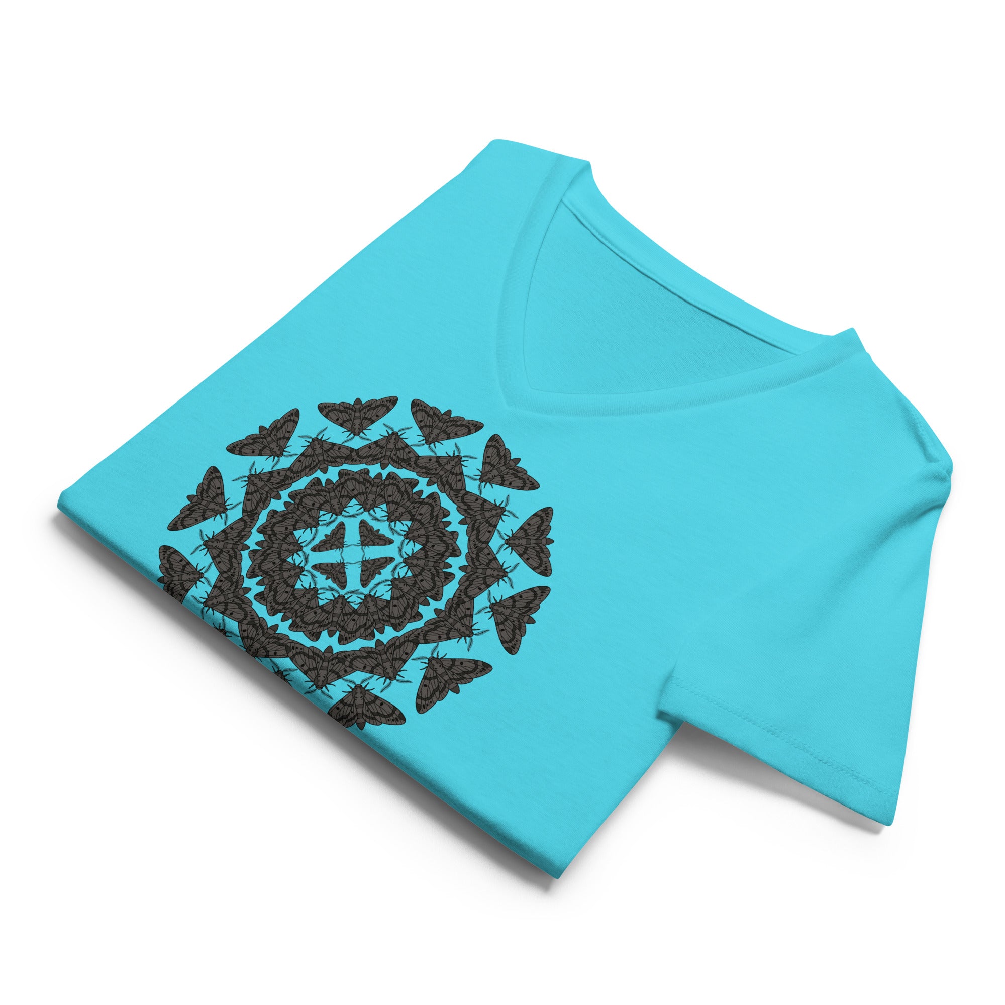 Folded teal v-neck t-shirt with a geometric pattern of the Blackburn's sphynx moth by Soon To Be Mythical